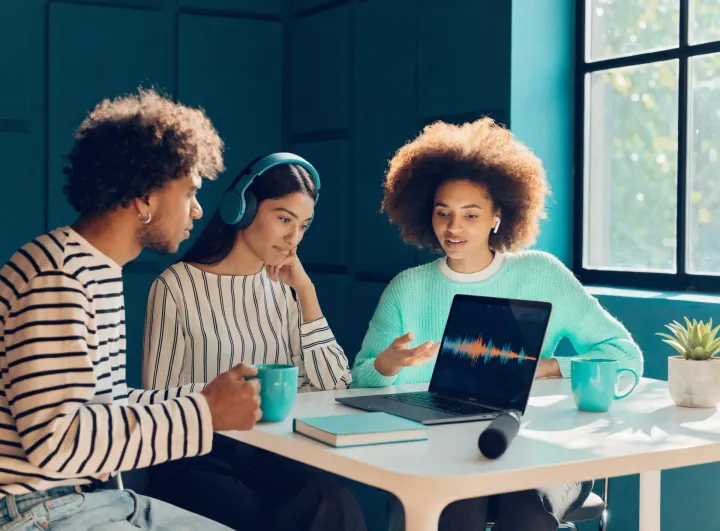 The HiveCast team reviewing an episode together in a bright studio